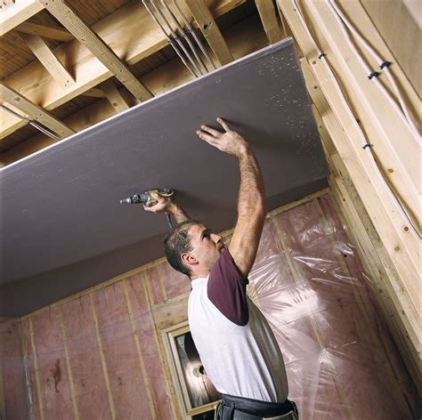 hanging sheets of drywall